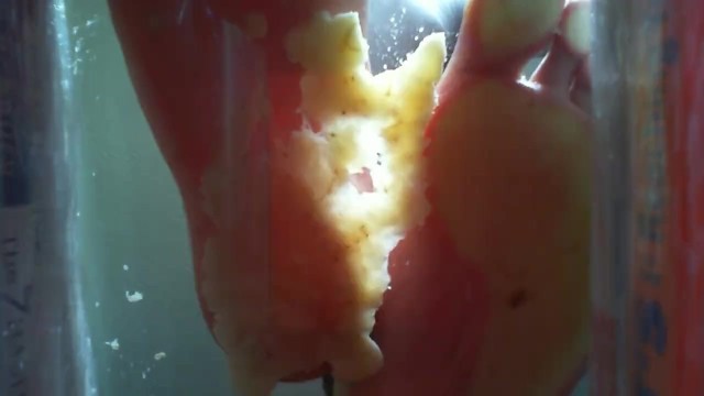 Banana crush male feet under glass POV